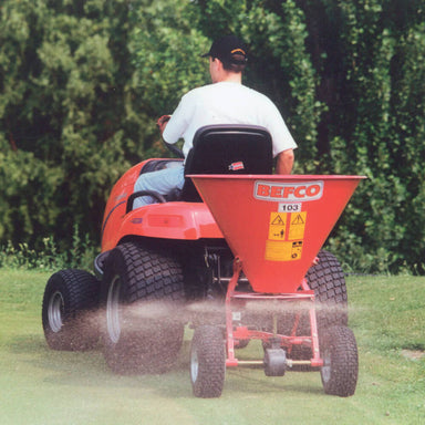 BEFCO Baby Hop Spreader, red, rear view, mounted on tractor, with wide hopper and spreading action.