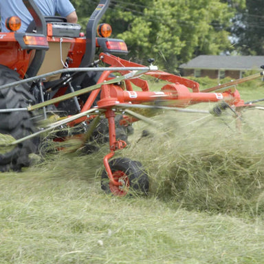 BEFCO Hay Tedder Rake DRP-300 angled view, orange with rotating tines for efficient hay spreading.