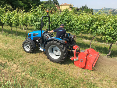BEFCO Hurricane H40-S Flail Mower attached to a blue tractor, angled view, bright red cutting deck.