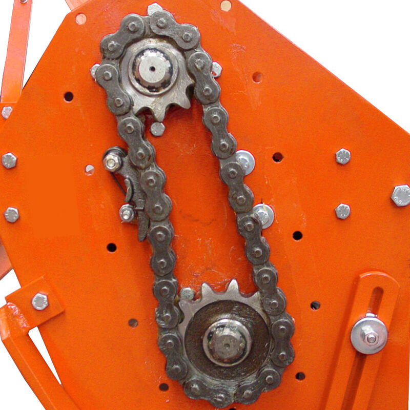 BEFCO T30 Rotary Tiller chain drive system close-up, featuring orange metal components and gears.