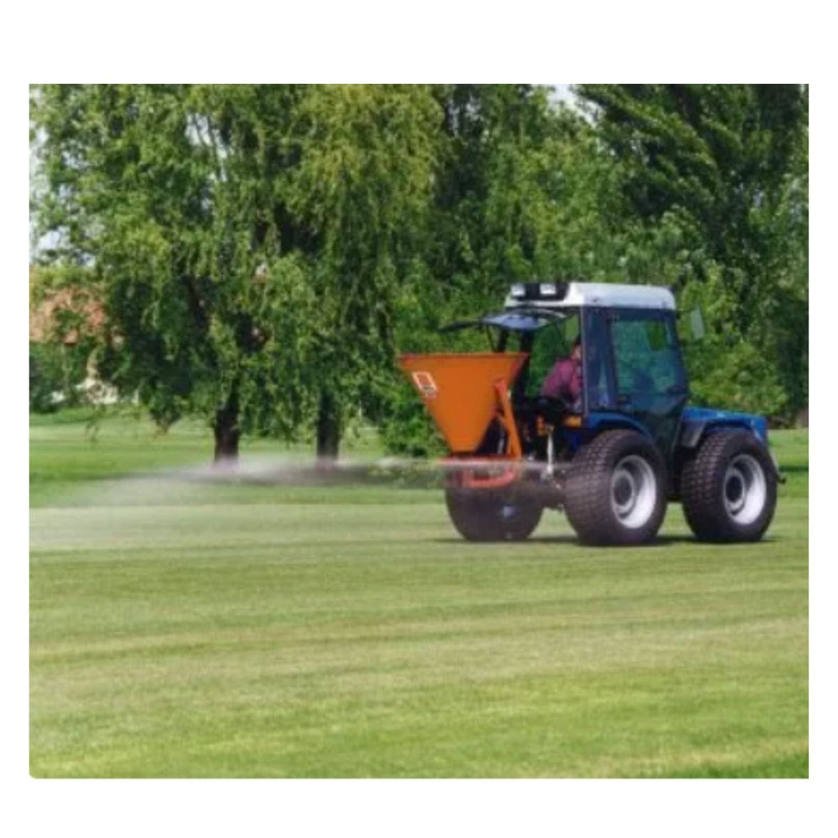 BEFCO Fertilizer Spreader on tractor, orange hopper, angled view, suitable for lawn care.