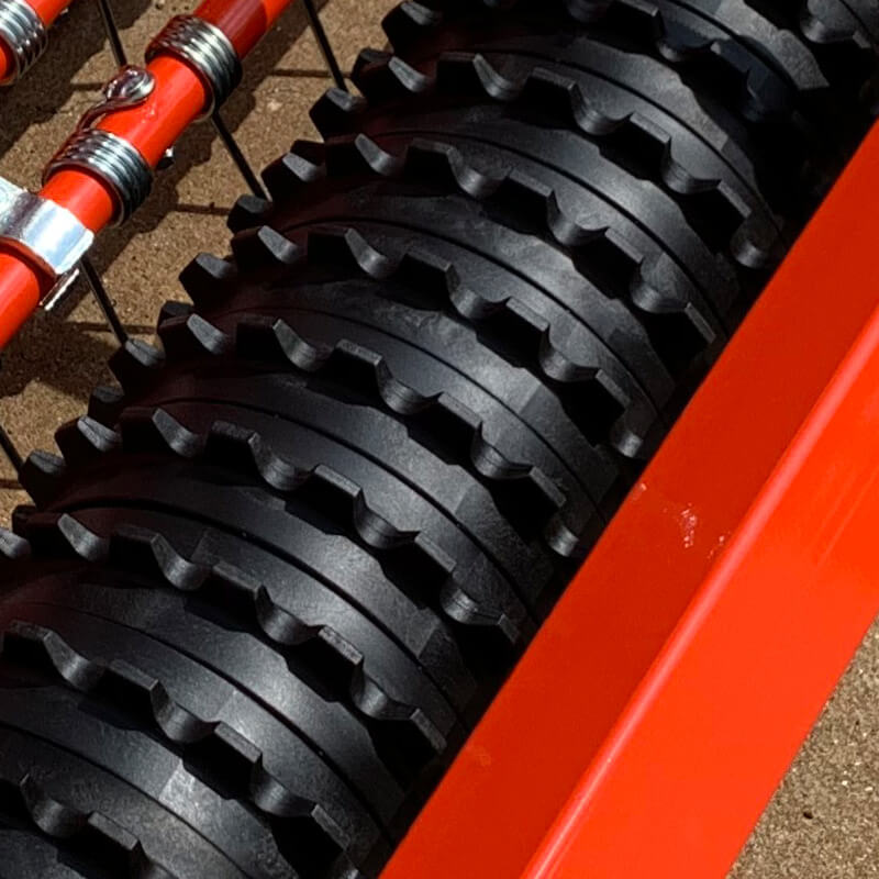 BEFCO Green-Rite Seeder and Aerator, top view, featuring red body and black aeration wheels.