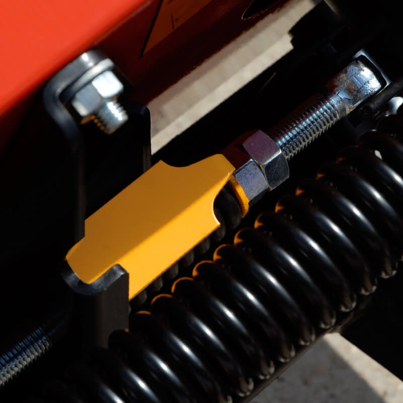 BEFCO Sickle Bar Mower close-up, featuring yellow and metal components with coil spring.
