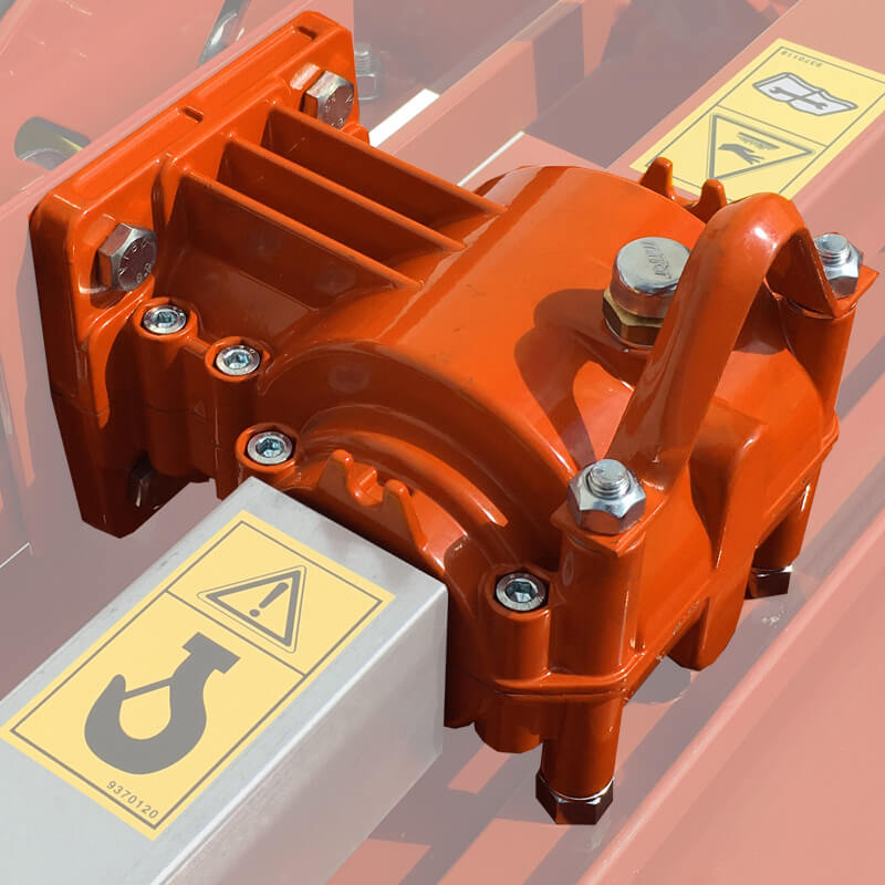 BEFCO T30 Rotary Tiller detailed view of orange gearbox with warning labels and metal housing.