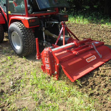 BEFCO T40 Rotary Tiller, red, angled view with tines and attachment to tractor.
