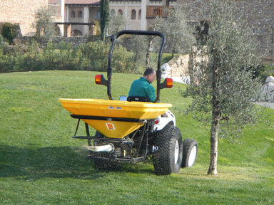 BEFCO Turbo Hop 303 Pendulum Spreader, yellow, rear view with large wheels for stability.