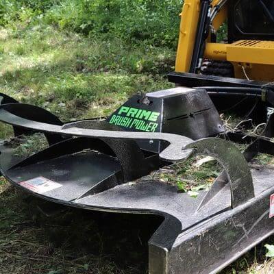 Prime Attachments Brush Mower Attachment, black, angled view with curved blades and branding.