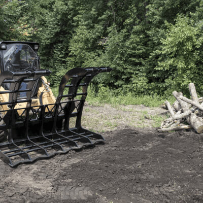 Forestry Grapple for Skid Steer by Prime Attachments, black, angled view, designed for log handling.