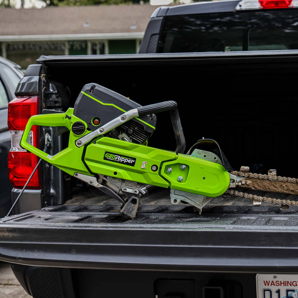 GeoRipper GR27 Trencher in green, featuring a handle and exposed chain, angled view.