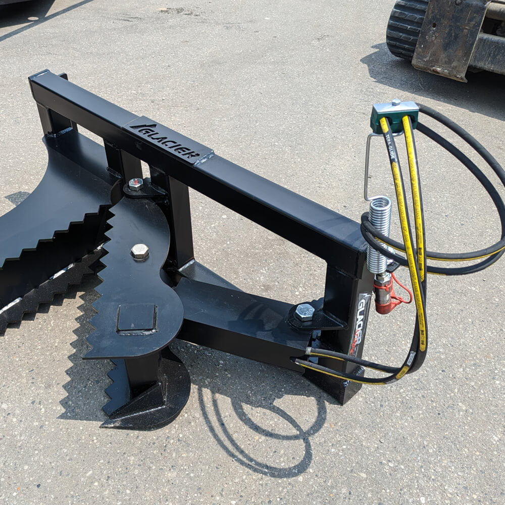 Glacier Attachments Skid Steer Tree Puller, black with serrated gripping edges and hydraulic hoses.