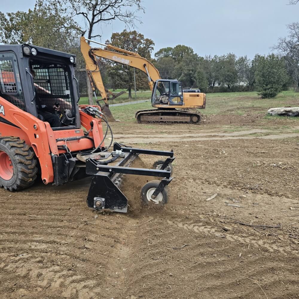 HD Soil Conditioner by Prime Attachments, black, front view with angled tines for soil preparation.