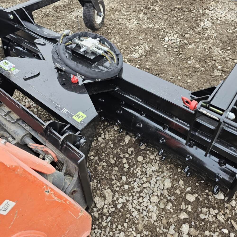 HD Soil Conditioner by Prime Attachments angled view, black with wheels and hydraulic connections.