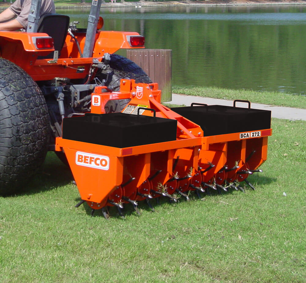 BEFCO Heavy Duty 3 Point Core Aerator, orange, featuring tines and attachment hooks, rear view.