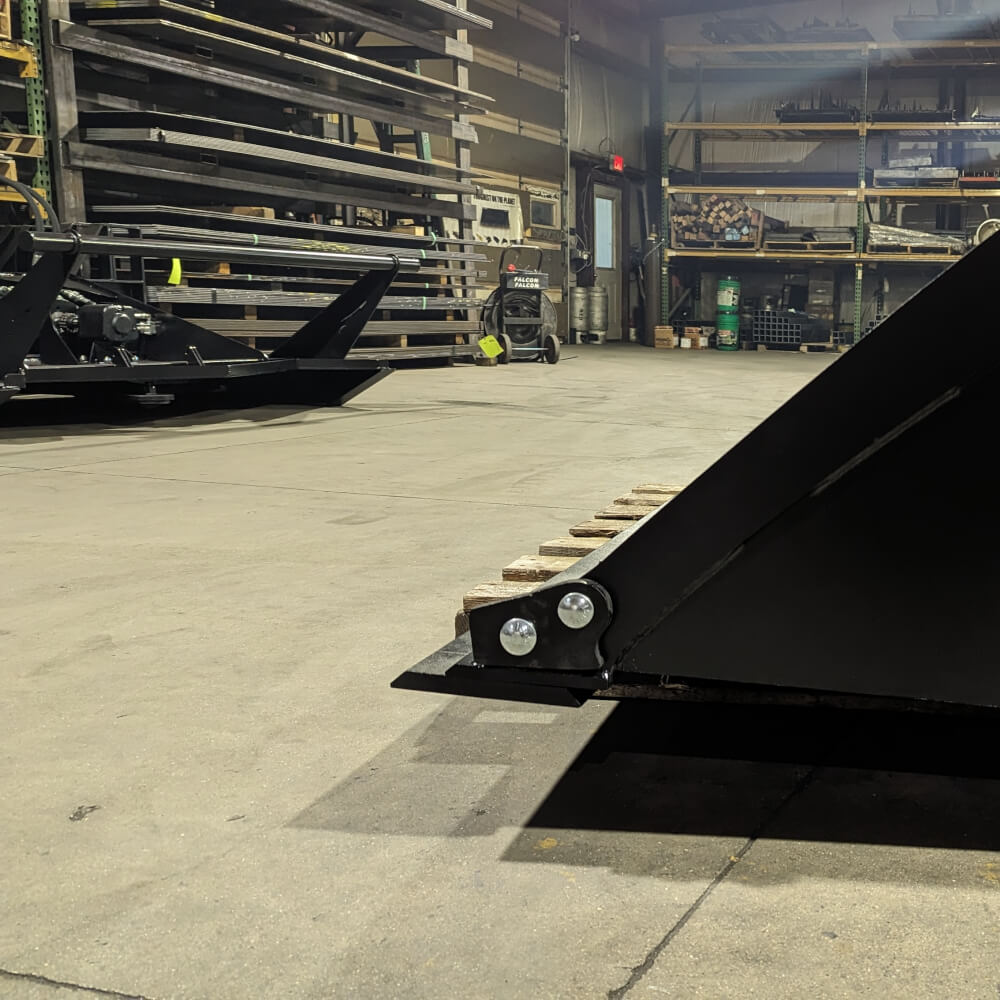 Heavy Duty Bucket for Skid Steer by Glacier Attachments, black with angled design and robust build.