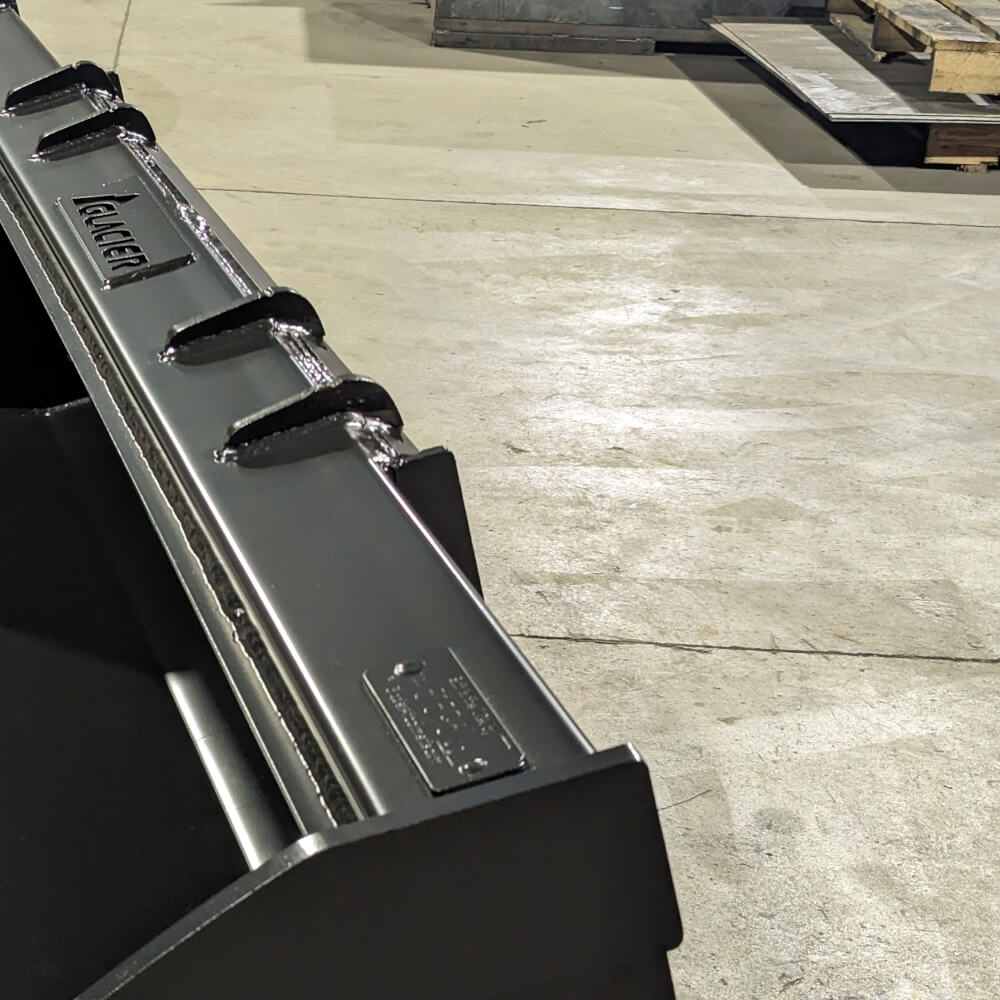 Heavy Duty Bucket for Skid Steer by Glacier Attachments, front view, black with reinforced edges.