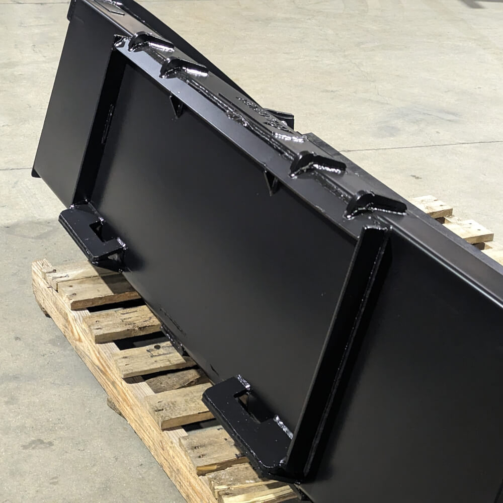 Glacier Attachments heavy-duty bucket for skid steer, black, angled view on wooden pallet.