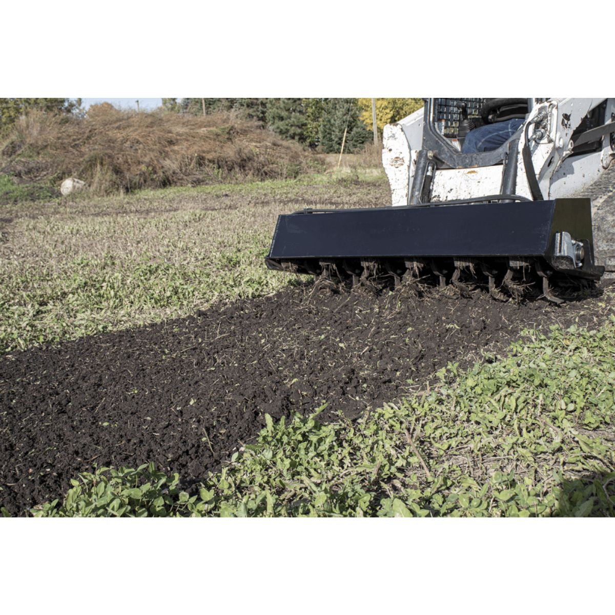 Prime Attachments skid steer tiller attachment to prepare soil used outdoors