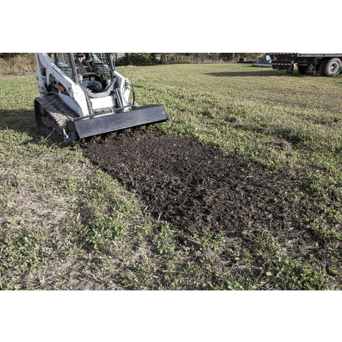Prime Attachments skid steer tiller attachment working in a field