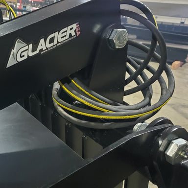 Glacier Attachments Rock and Brush Grapple close-up view showcasing hydraulic components and black finish.