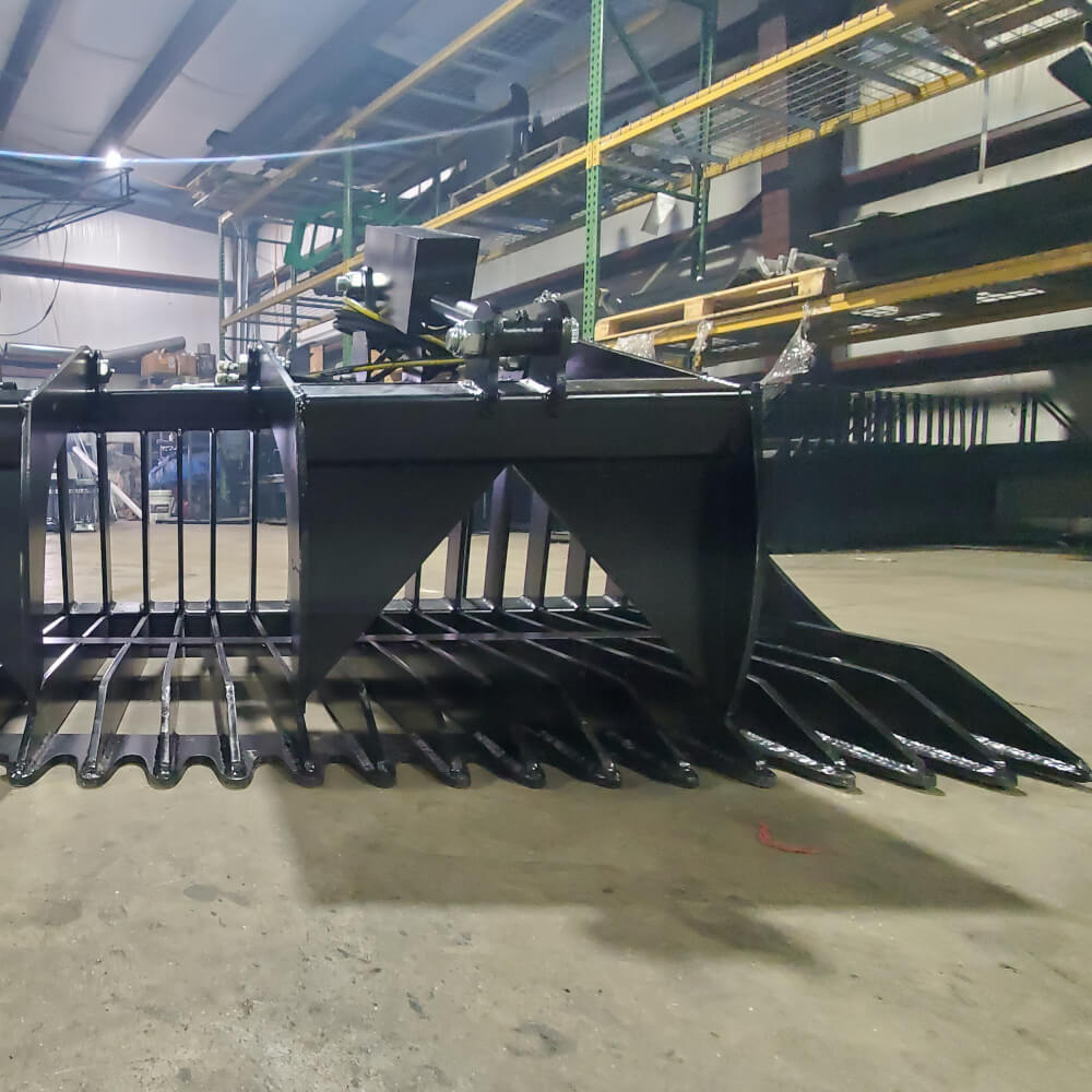 Rock and Brush Grapple — Glacier Attachments, front view, black with angled tines and sturdy build.