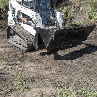 Prime Attachments Skid Steer 4-in-1 Bucket angled view, black with durable design and wide scoop.
