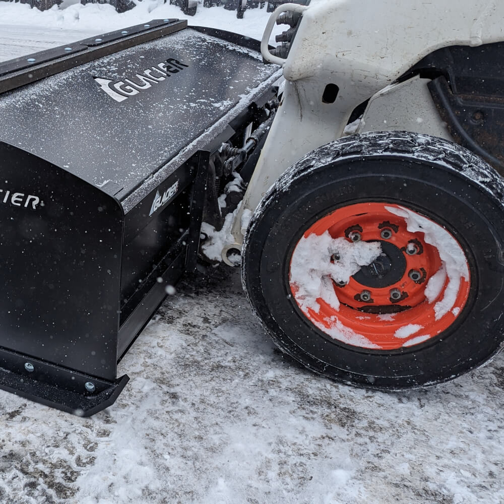 Glacier Attachments Heavy Duty Snow Pusher, black with steel blade, angled view on equipment.