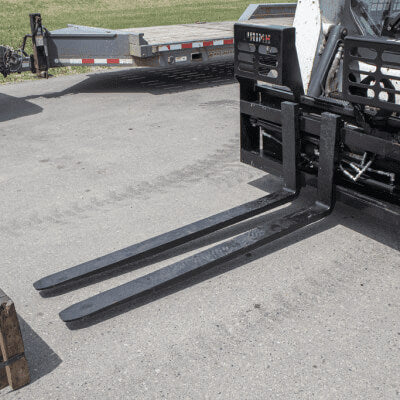 Skid Steer Hydraulic Adjustable Forks by Prime Attachments, black, angled view with long forks.