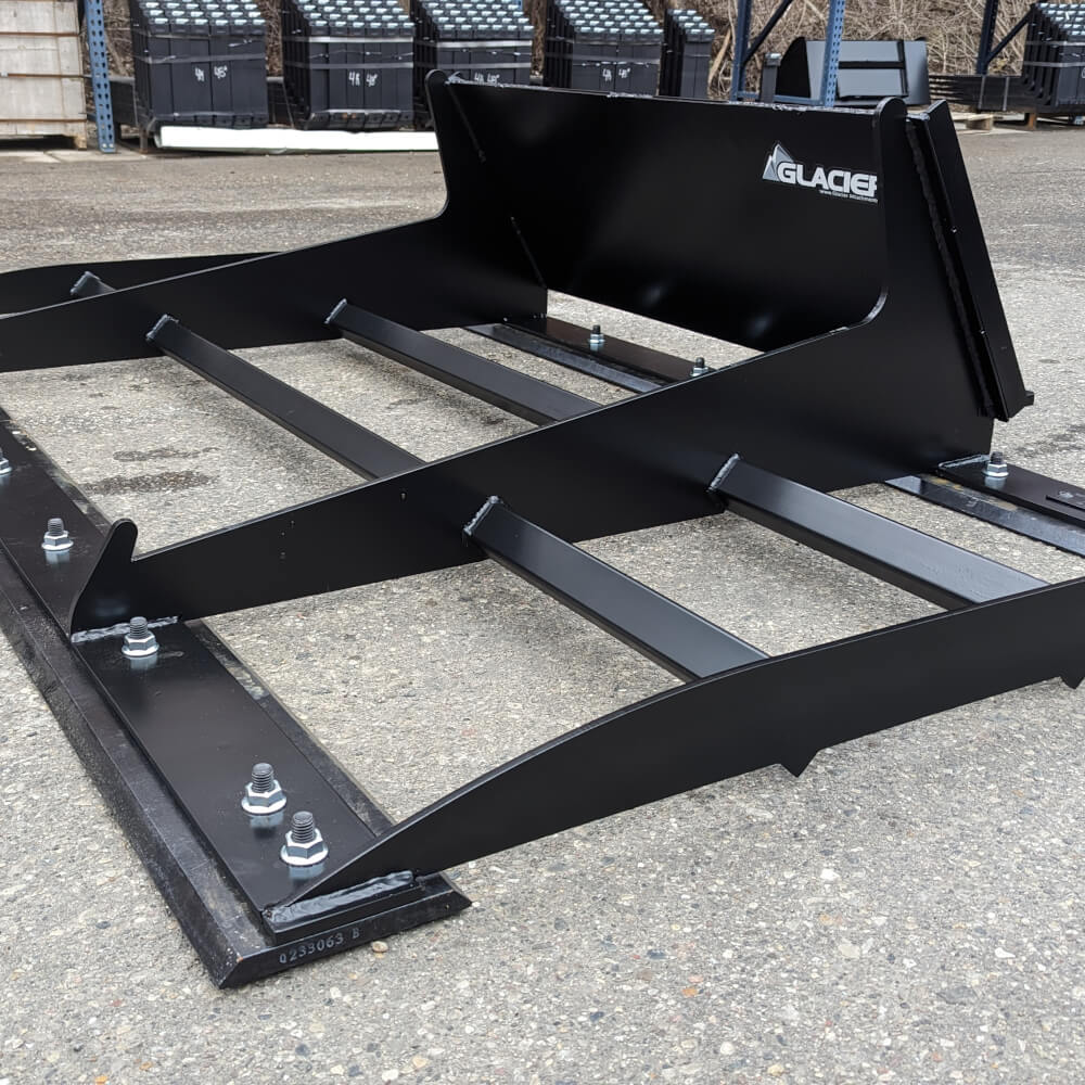 Glacier Attachments skid steer land plane attachment, black, angled view with metal construction and bolts.