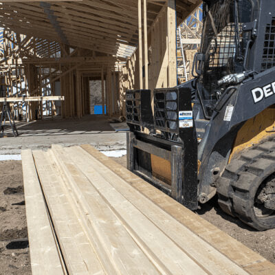 Prime Attachments Skid Steer Pallet Fork Attachments angled view, black with robust fork design.