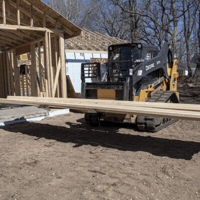 Skid Steer Pallet Fork Attachments by Prime Attachments, angled view with yellow and black coloring.