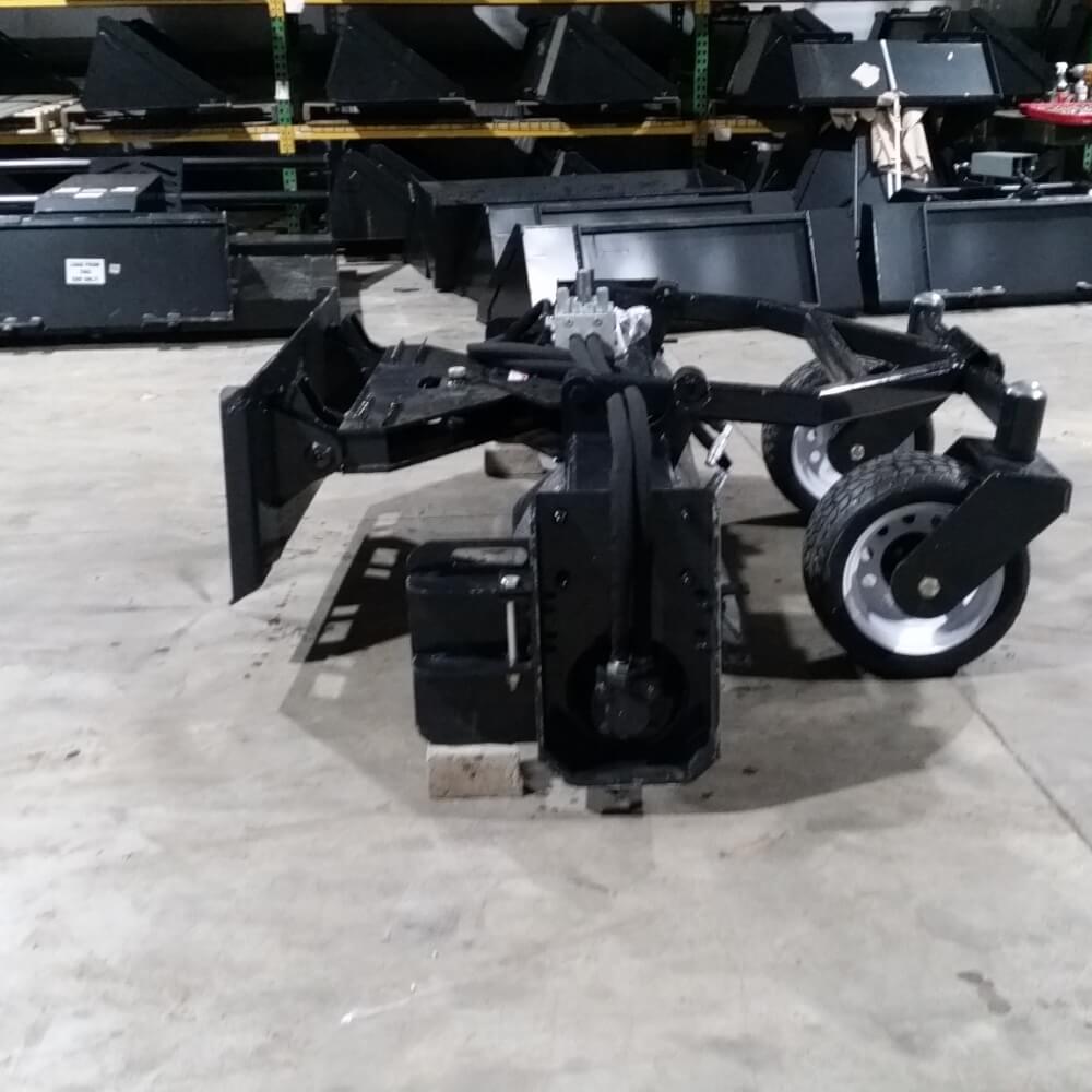 Skid Steer Soil Conditioner by Glacier Attachments, angled view, featuring black color and wheels.