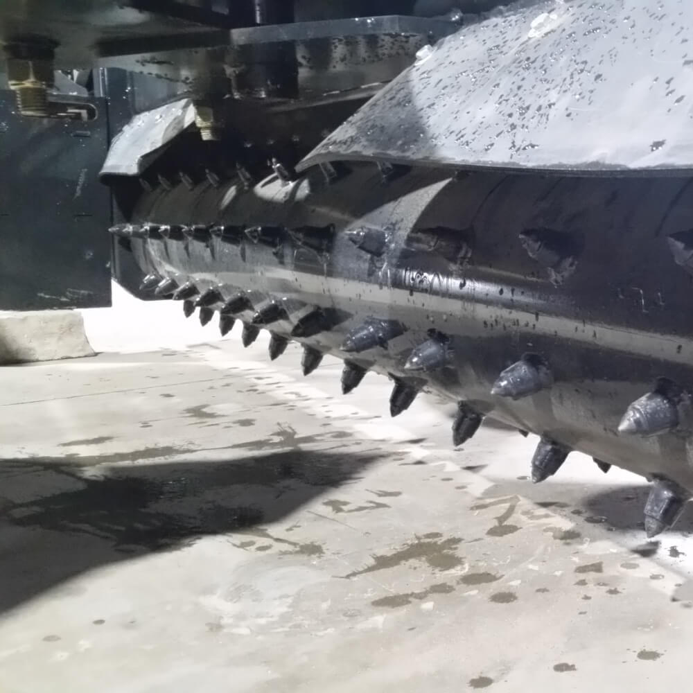 Skid Steer Soil Conditioner by Glacier Attachments, black metal body with spikes for efficient soil preparation.