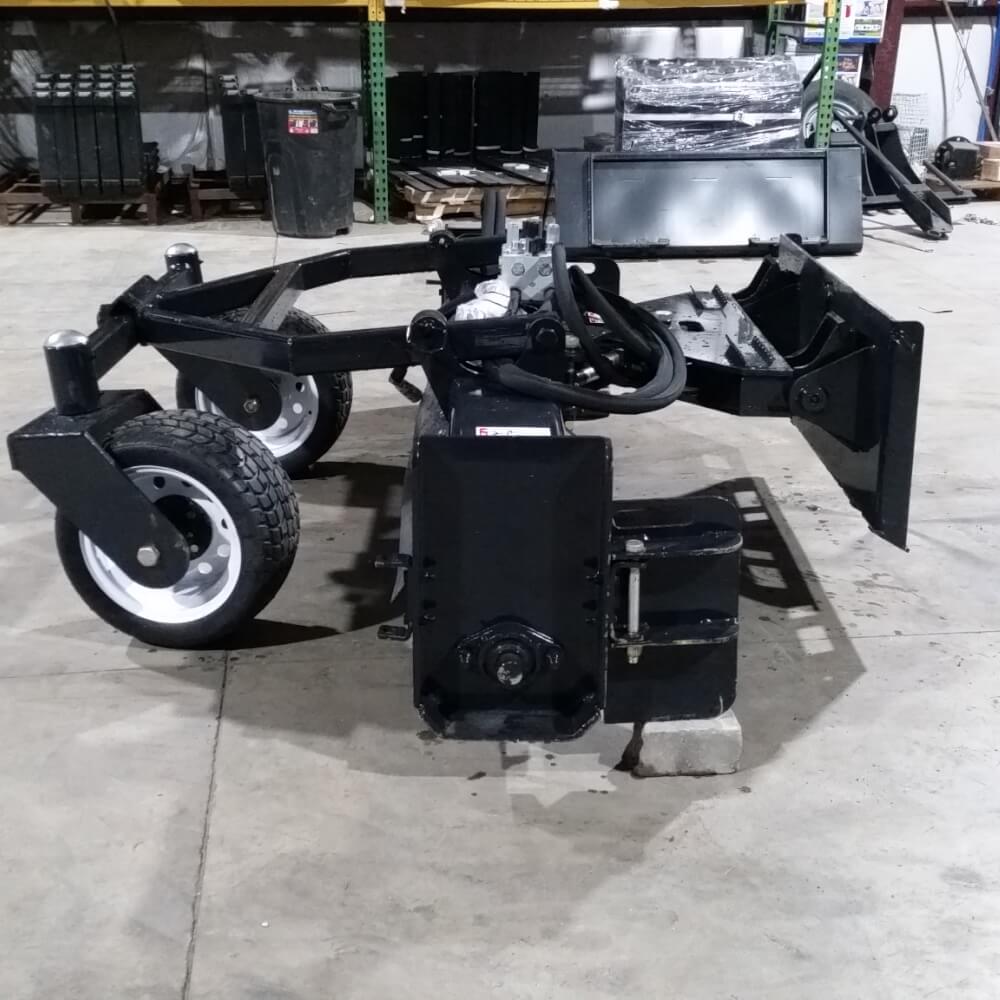 Skid Steer Soil Conditioner by Glacier Attachments, angled view, black with durable wheels and hydraulic features.