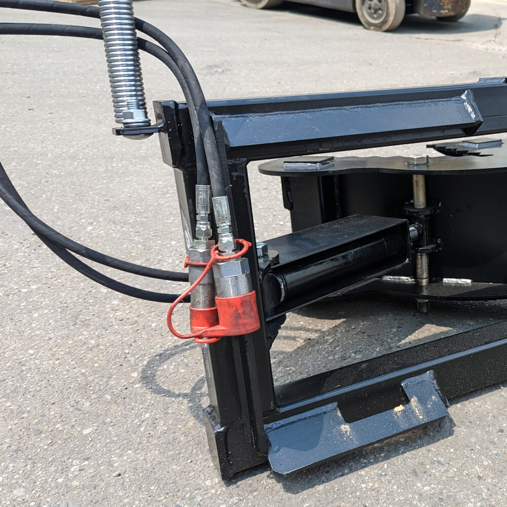 Glacier Attachments Skid Steer Tree Puller, black, angled view with hydraulic hoses and hardware details.
