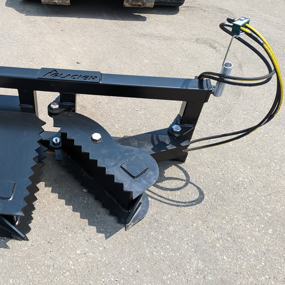 Glacier Attachments Skid Steer Tree Puller, black with serrated jaws and hydraulic hoses.