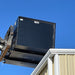 Star forklift trash hopper being lifted on jobsite