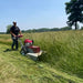 Ambush Brush Mower 26 In 10.5 HP red mower, angled view, with large wheels and handle.
