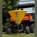 BEFCO Baby Hop Spreader yellow hopper, rear view, mounted on an orange utility vehicle.