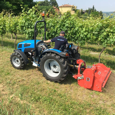 BEFCO Hurricane H40-S Flail Mower attached to a blue tractor, angled view, bright red cutting deck.