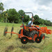 BEFCO RS2 V-Type Wheel Rake operating behind tractor while gathering hay