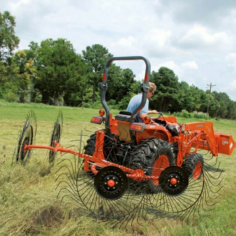 BEFCO RS2 V-Type Wheel Rake operating behind tractor while gathering hay