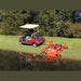 BEFCO Cyclone C30-CE5H grooming mower in orange, attached to a red golf cart, angled view.