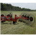 BEFCO Hay Rake, red and black, angled view with large rotating tines and wheels.