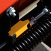 BEFCO Sickle Bar Mower close-up, featuring yellow and metal components with coil spring.
