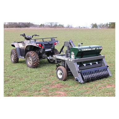 "Firminator G3 ATV/UTV cultivator with green and gray coloring, attached to an ATV."