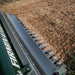 Firminator G3 cultivator disks with shiny metal blades, shown working on freshly tilled soil.