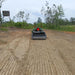 Firminator G3 - Disks and Cultipackers in green, working on freshly tilled soil outdoors.