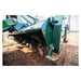 Firminator Rototiller RT features a robust green design with a 16-inch cultivating implement in action.