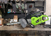GeoRipper 20 MiniTrencher side view, vibrant green and black with a cutting chain and handle.