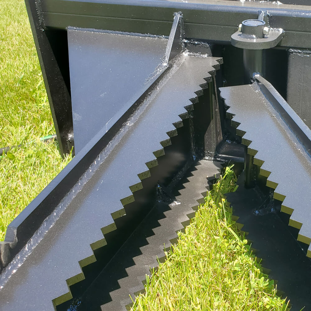 Glacier Stump Shark angled view, black with serrated edges and hydraulic attachment features.